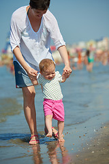 Image showing mom and baby on beach  have fun