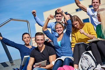 Image showing students outside sitting on steps