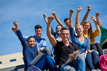 Image showing students outside sitting on steps