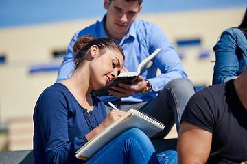 Image showing students outside sitting on steps