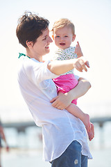 Image showing mom and baby on beach  have fun