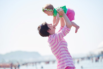 Image showing mom and baby on beach  have fun