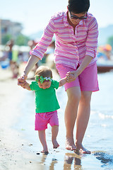 Image showing mom and baby on beach  have fun