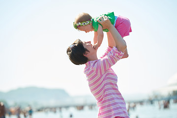 Image showing mom and baby on beach  have fun