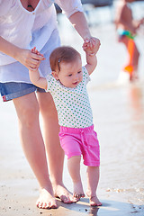 Image showing mom and baby on beach  have fun