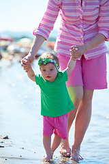 Image showing mom and baby on beach  have fun