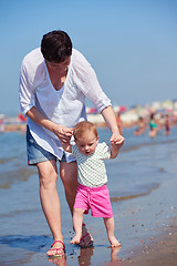 Image showing mom and baby on beach  have fun