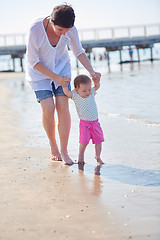 Image showing mom and baby on beach  have fun