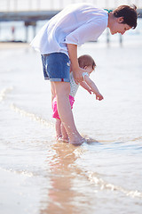 Image showing mom and baby on beach  have fun