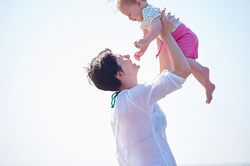 Image showing mom and baby on beach  have fun