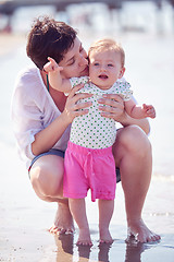 Image showing mom and baby on beach  have fun