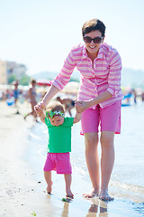 Image showing mom and baby on beach  have fun