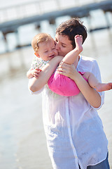 Image showing mom and baby on beach  have fun