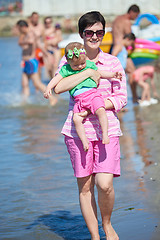 Image showing mom and baby on beach  have fun