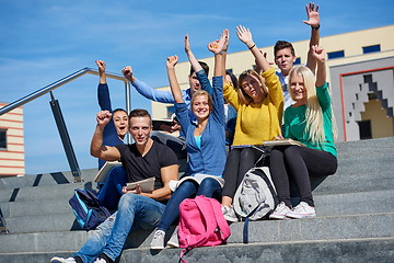 Image showing students outside sitting on steps