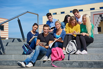 Image showing students outside sitting on steps