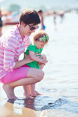 Image showing mom and baby on beach  have fun