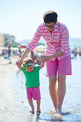 Image showing mom and baby on beach  have fun