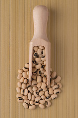 Image showing Wooden scoop with white beans