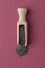 Image showing Wooden scoop with poppy seeds