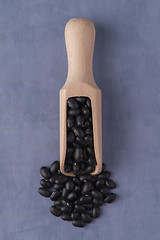 Image showing Wooden scoop with black beans