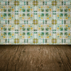 Image showing Wood table top and blur vintage ceramic tile pattern wall