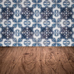 Image showing Wood table top and blur vintage ceramic tile pattern wall