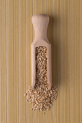 Image showing Wooden scoop with sesame seeds