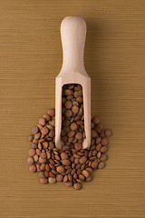 Image showing Wooden scoop with lentils