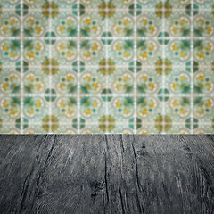 Image showing Wood table top and blur vintage ceramic tile pattern wall