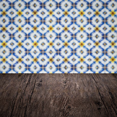 Image showing Wood table top and blur vintage ceramic tile pattern wall