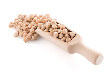 Image showing Uncooked chickpeas and wooden scoop