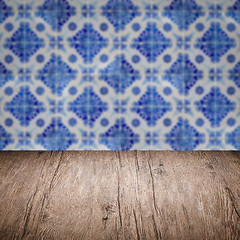 Image showing Wood table top and blur vintage ceramic tile pattern wall