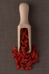 Image showing Wooden scoop with dry red goji berries