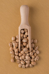 Image showing Wooden scoop with chickpeas