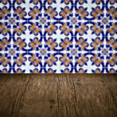 Image showing Wood table top and blur vintage ceramic tile pattern wall