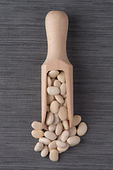 Image showing Wooden scoop with white beans