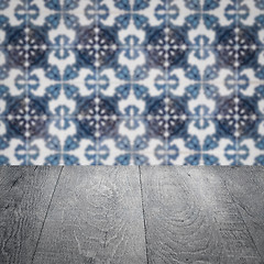 Image showing Wood table top and blur vintage ceramic tile pattern wall