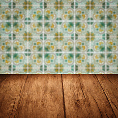 Image showing Wood table top and blur vintage ceramic tile pattern wall