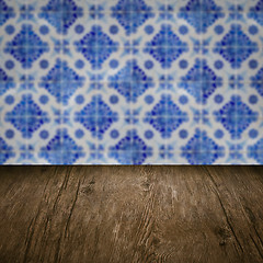 Image showing Wood table top and blur vintage ceramic tile pattern wall