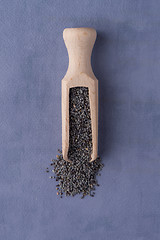 Image showing Wooden scoop with poppy seeds