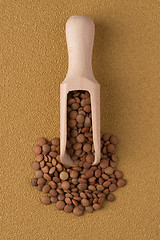 Image showing Wooden scoop with lentils