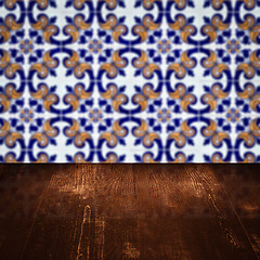 Image showing Wood table top and blur vintage ceramic tile pattern wall