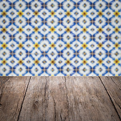 Image showing Wood table top and blur vintage ceramic tile pattern wall