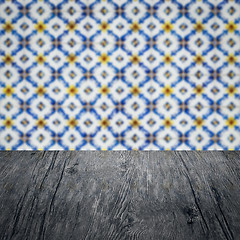 Image showing Wood table top and blur vintage ceramic tile pattern wall