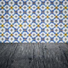 Image showing Wood table top and blur vintage ceramic tile pattern wall