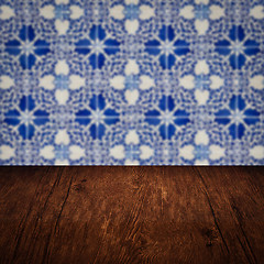 Image showing Wood table top and blur vintage ceramic tile pattern wall