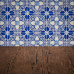 Image showing Wood table top and blur vintage ceramic tile pattern wall