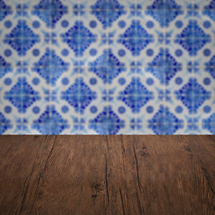 Image showing Wood table top and blur vintage ceramic tile pattern wall