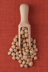 Image showing Wooden scoop with chickpeas